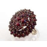 A Bohemian garnet cluster ring, composed of three tiers, mounted in silver gilt, the shank