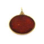 A large oval Islamic taweez, talisman, the geometric and numeric design carved on red hardstone in a