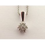 A diamond cluster pendant, the small flower cluster 6.3mm diameter, the white metal bale stamped '