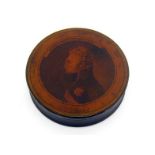An early 19th. century lacquered papier mache circular box, the lid with a bust of Alexander the