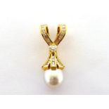 A diamond and South Sea cultured pearl pendant, set to the centre with a heart cut diamond, a 12mm