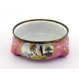 An 18th. century enamelled cauldron salt with applied gilt rim on three rudimentary stump feet,