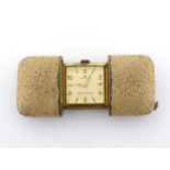 A 1920s gilt metal purse watch, the square case with silvered dial, signed 'Heritage', with date