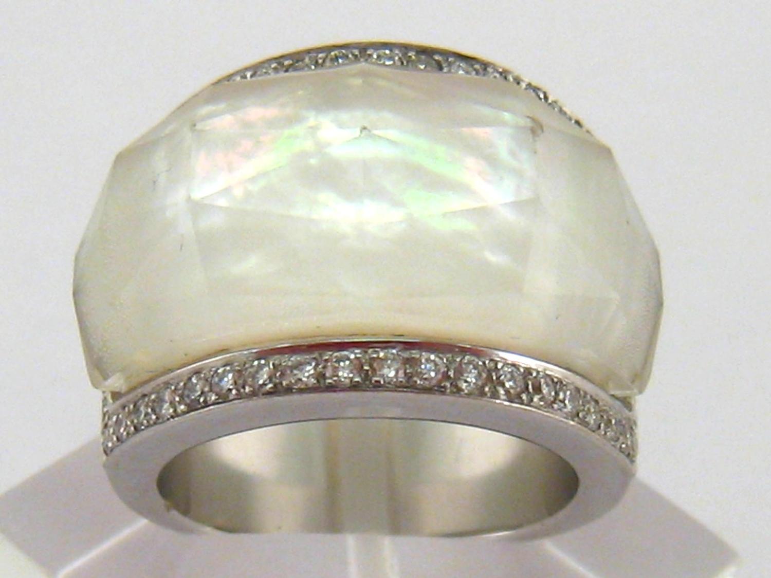 A diamond and mother of pearl dress ring, the large facetted crystal bezel overlaying the mother-