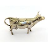 A German .800 standard silver cow creamer, 20th century, with hinged cover, marked on tail, 14 cm.