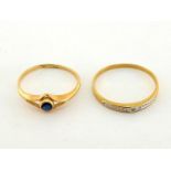Two French 18 carat gold rings, the first set with a small round cut sapphire, the second with a