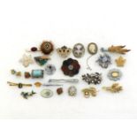 An antique “pebble” brooch, together with a quantity of costume jewellery brooches and tie clips,