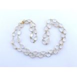 A moonstone necklace, composed of uniform 8.9 x 6.2mm spectacle set oval cabochon cut stones, the