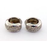 A pair of French 18 carat white gold and diamond earrings, the half hoops each with a panel of