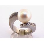 A diamond and South Sea cultured pearl ring, the large pearl 12.3mm tension set between pave set