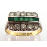 An emerald and diamond ring, the channel set calibre cut emeralds between two rows of brilliants,