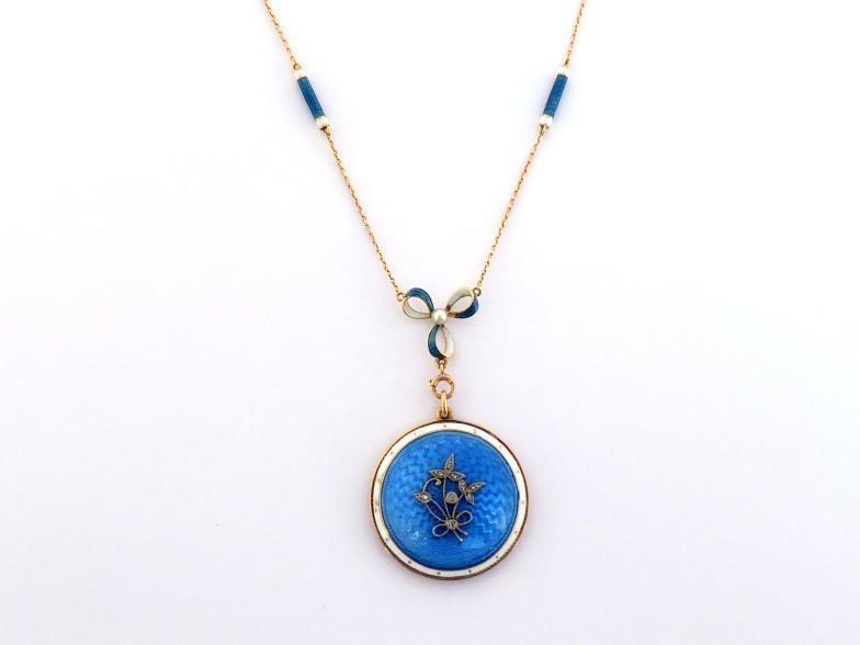 An early 20th century guilloche enamel and diamond locket, circa 1900, the round locket with a