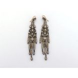 A pair of early 20th century paste set chandelier earrings, each mounted in silver, with gold hook