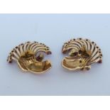 A pair of 1950s yellow metal (tests 14 carat gold) and ruby earrings, the stylised sheaf design with