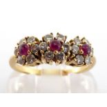 A ruby and diamond triple cluster ring, each brilliant cut cluster centred on a small ruby cabochon,