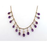 An early 20th century amethyst and split pearl fringe necklace, the fringe composed of slightly