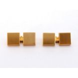 A pair of yellow metal (tests 18 carat gold) cuff links, the square brushed gold links 8 x 8mm, 9.