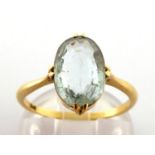 An aquamarine ring, the central oval cut stone 13 x 7.7 x 4.1mm, the yellow shank stamped '18k',