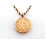 A Victorian gold locket and curb link chain, the circular locket 2.2cm wide, 9.6gms