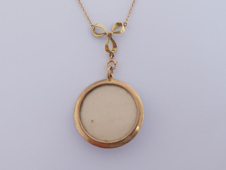 An early 20th century guilloche enamel and diamond locket, circa 1900, the round locket with a - Image 4 of 4