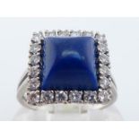A lapis lazuli and diamond ring, the square lapis cabochon 8.1 x 8.1mm, in a surround of brilliants,