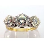 An 18 carat gold and diamond three stone ring, the three graduated brilliants totalling approx. 2.05