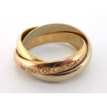 Cartier, Must de Cartier, an 18 carat three colour gold 'Trinity' ring, signed to outer shank,