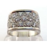 A diamond dress ring, the central panel pave set with 19 brilliants, totalling approx. 1.2 carats,