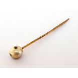 A 19th century freshwater pearl and diamond stick pin, the off round pearl 10.6 x 10mm, a small rose