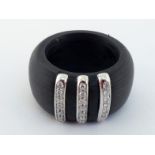 A graphite and diamond designer ring, the broad graphite band set to the centre with three rows of