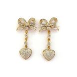 A pair of diamond bow ear studs, pave set overall with single cuts, an old brilliant to the