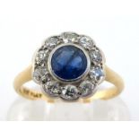 An early 20th century sapphire and diamond cluster ring, the central round cut sapphire 4.8 x 2.4mm,