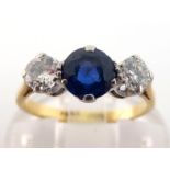 A diamond and sapphire three stone ring, the central round cut sapphire 5.5 x 3.5mm, between two old