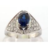 A sapphire and diamond ring, the central oval cut sapphire approx. 0.75 carat, between two