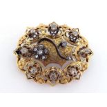 A Victorian gold and diamond brooch, of oval openwork design, engraved to the central panel, set