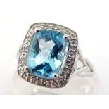 A 9 carat white gold, blue topaz and diamond ring, the rectangular cushion chequerboard cut stone