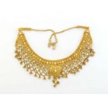 A 22 carat gold fringe necklace, the fine filigree fringe accented with white brilliant cut