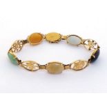 A coloured jadeite bracelet, composed of alternate oval cabochon stones, with Chinese character