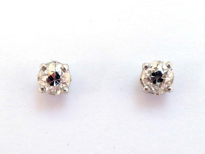 A pair of single stone diamond ear studs, each old brilliant cut stone approx. 0.57 carat,