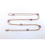 An amethyst-set long chain, the yellow metal (tests 9 carat gold) chain set along its length with