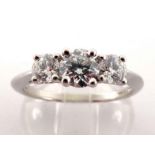 Tiffany & Co., a three stone diamond ring, set with three graduated brilliants, the central stone