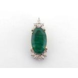 An emerald and diamond pendant, the central oval cut emerald 22 x 12.9 x 6.9mm, with a spray of