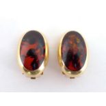 Willy Jagert for Halberstadt, a pair of 14 carat gold and amber earrings, the oval cabochons 16mm