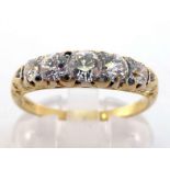 A diamond five stone ring, composed of five graduated old brilliant cuts, to a scroll gallery mount,