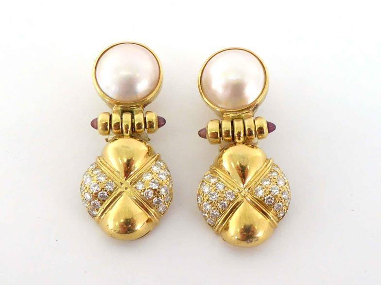 A pair of ruby, diamond and mabe pearl ear clips, the quatrefoil drop pave set with small