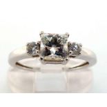 A diamond ring, the central princess cut stone approx. 0.87 carat, to small brilliant cut shoulders,