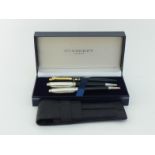 Burberry, three rollerball pens, including two black lacquer examples with palladium finish trim,