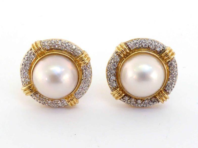 A pair of diamond and mabe pearl earrings, the central pearl 13mm diameter, in a surround of pave