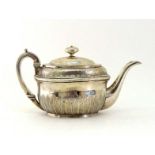 A George III silver oval teapot by John Emes, London, 1802, lower body engraved with band of stiff