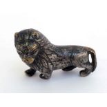 An Indo- Persian silvered brass standing lion, the head turned to the left, with well detailed